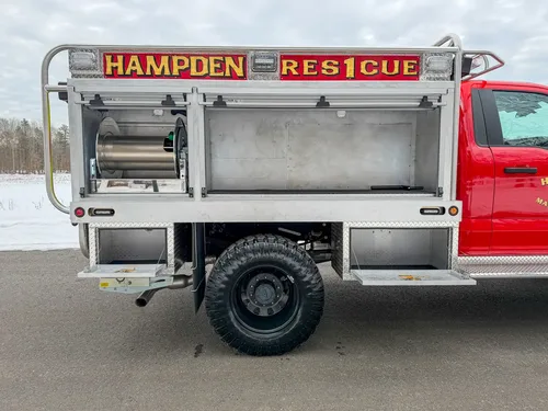 Passenger-side profile with one upper compartment door open.